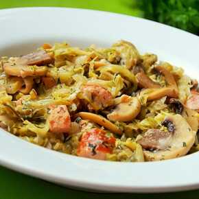 Young cabbage with mushrooms and sausage