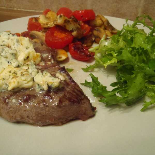 Beef steak with gorgonzola with grilled mushrooms and cherry tomatoes on the side